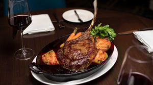 Tomahawk Steak with red wine at Charlie Palmer Steak Reno.