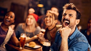 image of man screaming while watching sports game with his friends