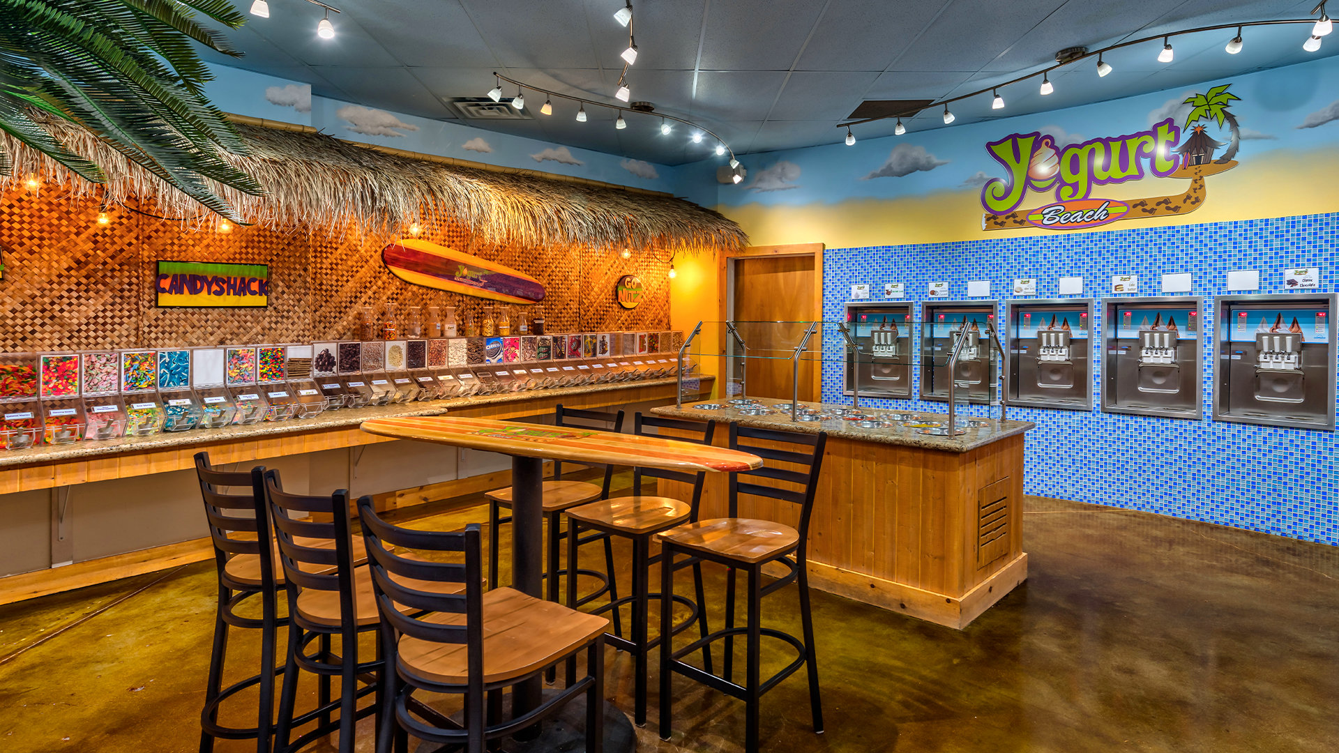 a colorful dining area with a yogurt and candy shop