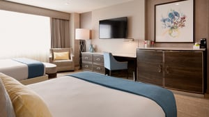 Sierra Two Queen Room view of bed and living space.