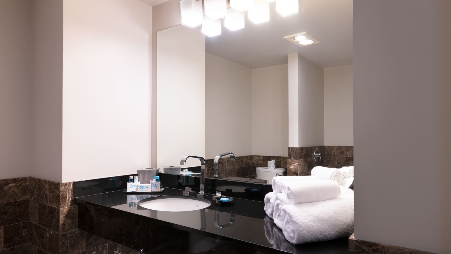 a bathroom with a black countertop and white towels