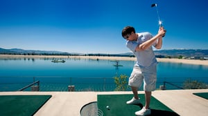 Photo of young man taking a swing at Grand Bay Aqua Range.