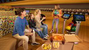 Photo of family having fun and snacks in Grand Bowling Center at GSR.