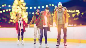 Photo of friends gliding hand-in-hand at The Ice Rink.
