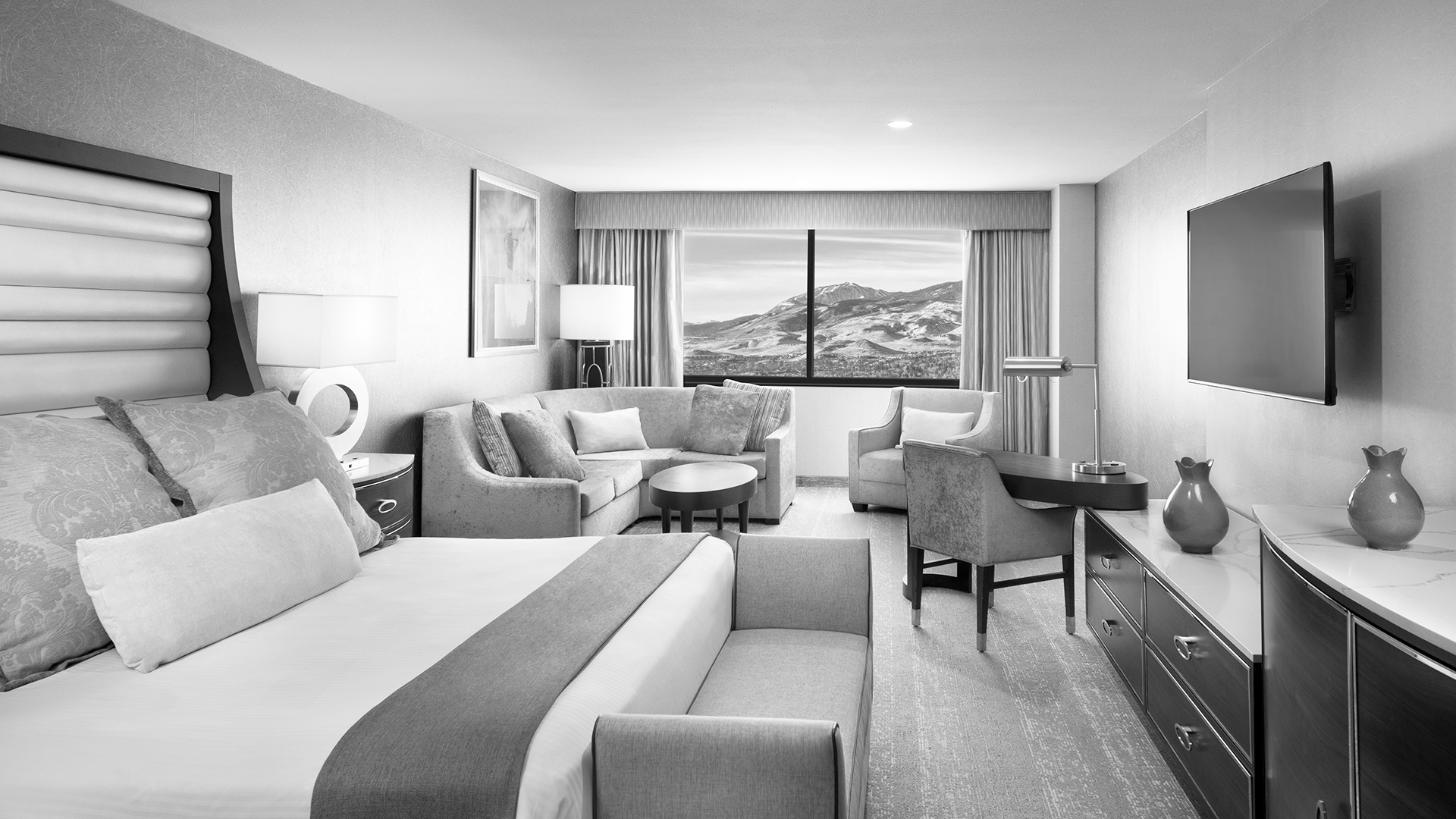 The A Deluxe King Room View of Main Room in Grayscale